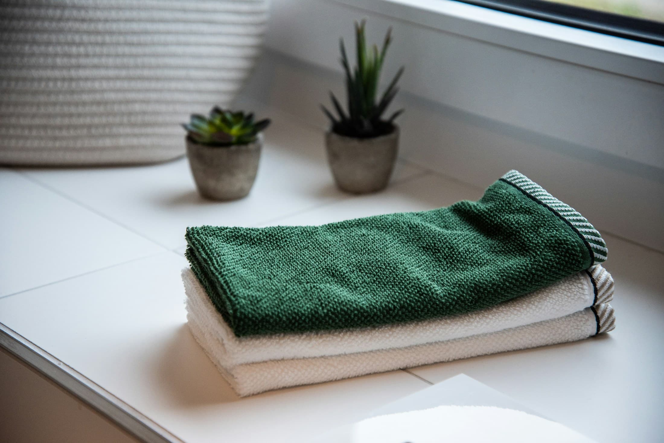 Freshly folded CleNest laundry in a calm home